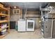 Basement laundry area featuring washer, dryer, shelving, and utilities at 12927 W 20Th Ave, Golden, CO 80401