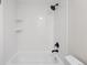 Updated bathroom features a white tub and shower with matte black fixtures at 12927 W 20Th Ave, Golden, CO 80401