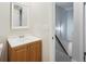 Bathroom with vanity, mirror, and doorway to stairs at 12927 W 20Th Ave, Golden, CO 80401