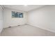 Bright bedroom with neutral carpet, window, and bi-fold closet doors at 12927 W 20Th Ave, Golden, CO 80401