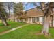 View of a townhouse complex with mature trees and green lawns at 12927 W 20Th Ave, Golden, CO 80401