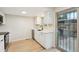 Bright kitchen with quartz countertops, stainless appliances, and sliding glass door access at 12927 W 20Th Ave, Golden, CO 80401