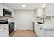 Bright kitchen with modern appliances, white cabinetry, and quartz countertops at 12927 W 20Th Ave, Golden, CO 80401