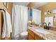 Bathroom with a sink, mirror, towels hanging on the towel bar and a shower curtain on the left at 12710 W 84Th Cir, Arvada, CO 80005