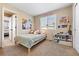 Cozy bedroom featuring a twin bed, window, and colorful decor, creating a playful and inviting atmosphere at 12710 W 84Th Cir, Arvada, CO 80005