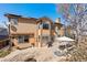 Tan two-story home with solar panels and outdoor patio perfect for entertaining at 12710 W 84Th Cir, Arvada, CO 80005