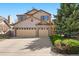 Charming two-story home with a well-manicured lawn and an attached two-car garage at 12710 W 84Th Cir, Arvada, CO 80005