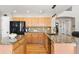 Bright kitchen featuring wooden cabinets, granite countertops, stainless steel appliances, and hardwood floors at 12710 W 84Th Cir, Arvada, CO 80005