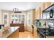 Sunlit kitchen with wooden cabinets, granite counters, stainless appliances, and breakfast bar at 12710 W 84Th Cir, Arvada, CO 80005