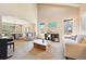 Bright living room featuring high ceilings, neutral tones, and plenty of natural light at 12710 W 84Th Cir, Arvada, CO 80005