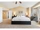 Main bedroom with a neutral color palette, vaulted ceiling, and a bay window with curtains at 12710 W 84Th Cir, Arvada, CO 80005