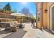 Outdoor patio complete with an umbrella, grill, and seating offering a relaxing retreat at 12710 W 84Th Cir, Arvada, CO 80005