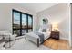 Bright bedroom with large window, hardwood floors, and comfortable seating at 6521 S Harlan Ct, Littleton, CO 80123