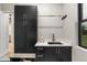Laundry room with ample cabinet space and a large utility sink at 6521 S Harlan Ct, Littleton, CO 80123