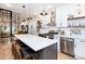 Modern kitchen boasts stainless steel appliances, white cabinets, quartz counters, and a large center island at 3443 Lawrence St, Denver, CO 80205