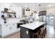 Modern kitchen with white shaker cabinets, large island, and stainless steel appliances at 3443 Lawrence St, Denver, CO 80205