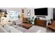 Bright living room with modern furniture and a large TV at 3443 Lawrence St, Denver, CO 80205