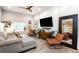 Spacious living room with sectional sofa, accent chairs, and large TV at 3443 Lawrence St, Denver, CO 80205