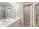 Bright bathroom featuring double sinks, a large mirror, and a walk-in shower for a spa-like experience at 5156 Bittercress Rd, Brighton, CO 80640