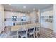 Bright kitchen featuring stainless steel appliances, a kitchen island and adjacent dining area at 5156 Bittercress Rd, Brighton, CO 80640