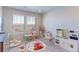Bright playroom with natural light, carpet, and toys to inspire creativity and imagination at 5156 Bittercress Rd, Brighton, CO 80640