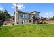 Back exterior of home with a large deck, stairs, and fenced-in yard at 7056 S Owens St, Littleton, CO 80127