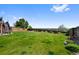 Beautifully maintained backyard with green grass and a wood fence at 7056 S Owens St, Littleton, CO 80127