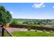 Enjoy this backyard view of the landscaped yard, fence line, mature trees, and the city beyond at 7056 S Owens St, Littleton, CO 80127