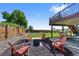 Charming backyard oasis with fire pit, Adirondack chairs, lush lawn, and a serene, natural setting at 7056 S Owens St, Littleton, CO 80127
