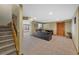 Spacious basement with carpeted floor and staircase with neutral walls at 7056 S Owens St, Littleton, CO 80127