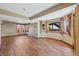 Basement room with a wood floor, windows, and neutral walls at 7056 S Owens St, Littleton, CO 80127