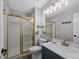 Nicely remodeled bathroom featuring a glass shower, newer vanity, and modern fixtures at 7056 S Owens St, Littleton, CO 80127