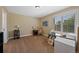 Bright bedroom with neutral walls, plush carpet, and a large window for natural light and views at 7056 S Owens St, Littleton, CO 80127