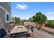 Relax on this deck with comfortable seating, table, and view of mountains, trees, and a beautiful blue sky at 7056 S Owens St, Littleton, CO 80127