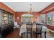Inviting dining room featuring hardwood floors, a chandelier, and access to other rooms at 7056 S Owens St, Littleton, CO 80127