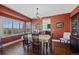 Elegant dining room with natural light, hardwood floors, and stylish chandelier at 7056 S Owens St, Littleton, CO 80127