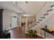 Grand foyer with hardwood flooring, a curved staircase, and an open layout at 7056 S Owens St, Littleton, CO 80127