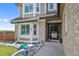 Inviting entryway featuring a decorative front door with sidelights, and manicured landscaping at 7056 S Owens St, Littleton, CO 80127