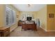 Inviting home office with a large window, neutral decor, and a functional workspace at 7056 S Owens St, Littleton, CO 80127
