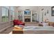 Bright living room featuring a fireplace, built-in shelving, and large windows for natural light at 7056 S Owens St, Littleton, CO 80127