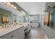 Elegant main bathroom featuring dual sinks, a soaking tub, and a separate glass shower creating a spa-like experience at 7056 S Owens St, Littleton, CO 80127