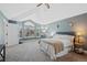 Bright main bedroom features a large window, plush carpet, and calming wall color for a relaxing space at 7056 S Owens St, Littleton, CO 80127