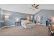 Spacious main bedroom boasts vaulted ceiling, soft blue walls, and ensuite access for a serene retreat at 7056 S Owens St, Littleton, CO 80127