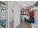 Organized walk-in closet featuring shelving, a chandelier, and ample storage for clothes and accessories at 7056 S Owens St, Littleton, CO 80127