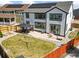 Well-maintained backyard with a patio, outdoor furniture, and a grassy yard with a fence and solar panels at 14920 Munich Ave, Parker, CO 80134