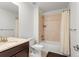 Bathroom featuring a shower-tub combo with a shower curtain, toilet, and dark wood cabinets at 14920 Munich Ave, Parker, CO 80134