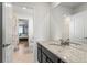 Well-lit bathroom with granite countertop and doorway to bedroom at 14920 Munich Ave, Parker, CO 80134