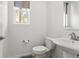 Cozy half bathroom featuring a pedestal sink, tiled floors, and a window for natural light at 14920 Munich Ave, Parker, CO 80134