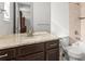 Modern bathroom featuring a granite vanity top, a sleek sink, and a convenient toilet at 14920 Munich Ave, Parker, CO 80134