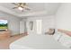 Bright main bedroom featuring a ceiling fan, large windows, and a modern dresser at 14920 Munich Ave, Parker, CO 80134